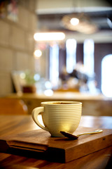 Hot coffee on wood table in cafe