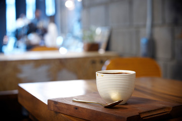 Hot coffee on wood table in cafe