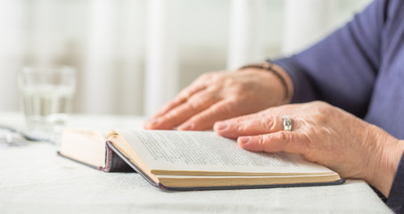 Elderly Caucasian Woman Reads A book. Pensioner Relaxation and brain education pleasure concept. Close Up.