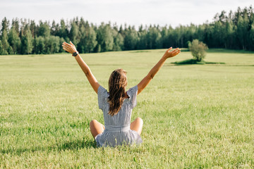 Beautiful girl in dress on green field