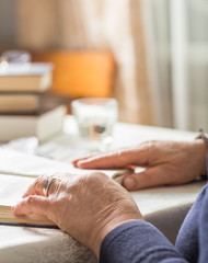 Elderly Caucasian Woman Reads A book. Pensioner Relaxation and brain education pleasure concept. Close Up.