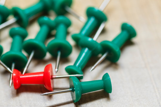Red and green pins placed on the wooden floor