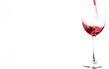 red wine pouring into wine glass isolated on a white background