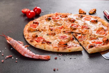 Foto op Plexiglas Tasty sliced pizza with seafood and tomato on a concrete background © chernikovatv