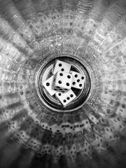 black and white photo of dice pyramid in the glass with nice reflection. 