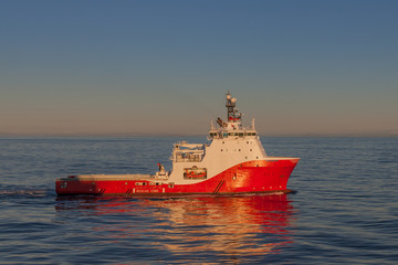 Fototapeta premium Offshore Anchor Handling vessel in the early morning in transit.