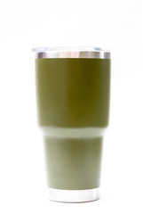 Green stainless steel thermos tumbler mug isolated on white background. Keeping a beverage cold or hot. Reduce plastic concept.