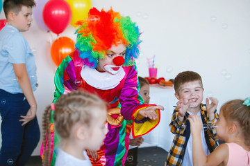 Children play with a clown
