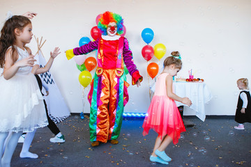 Children play with a clown