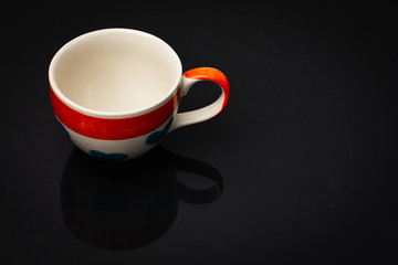 Empty coffee cup with heart pattern On a black background