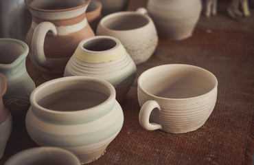 Many clay pot is on the table in pottery.