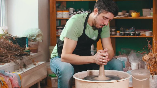 Pottery - the master is wetting the clay for better glide