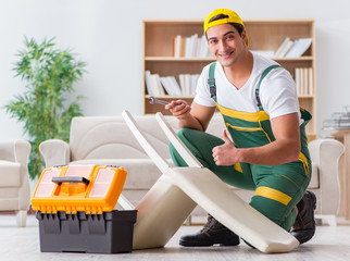Worker repairing furniture at home