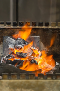 Closeup photo of hot flaming charcoal fire in grilling machine