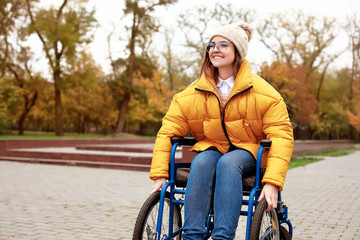 Handicapped young woman in autumn park