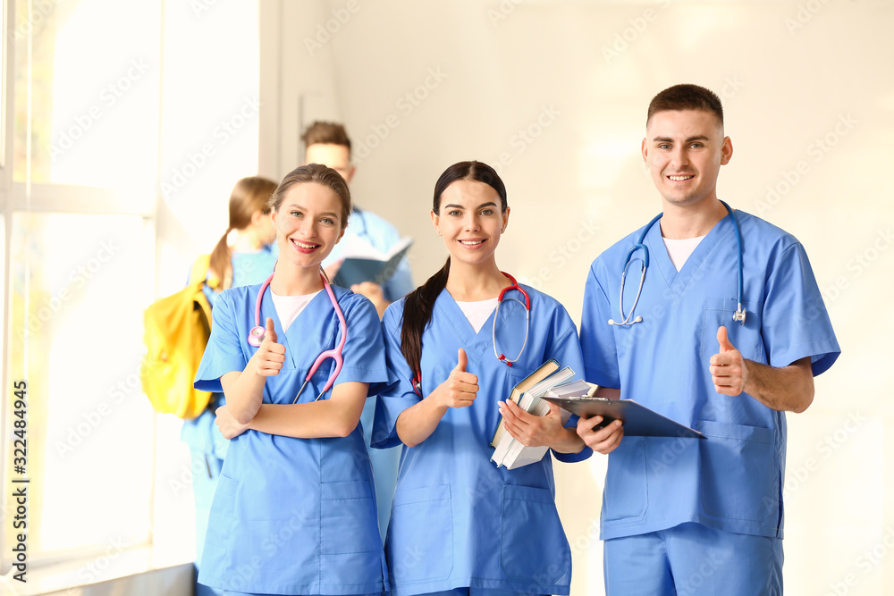 Sticker Group of medical students showing thumb-up gesture in hall of clinic