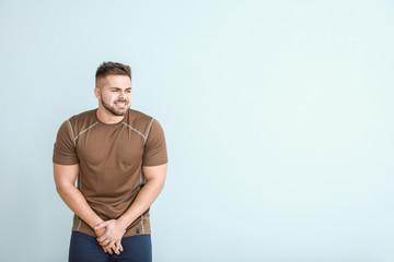 Young man with urologic disease on light background
