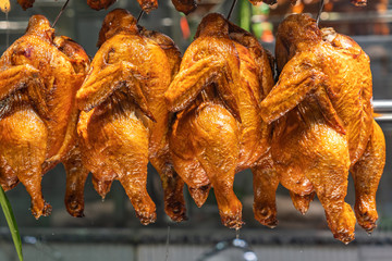 Closeup photo of roasted whole chickens at Chinese restaurant's showcase
