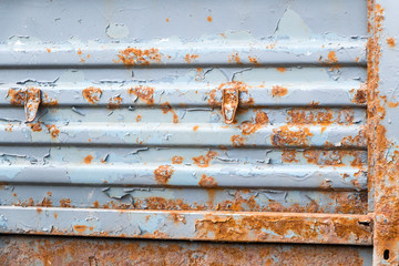Rust on the old painted metal ribbed surface