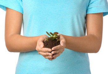 Woman with plant and soil on white background, closeup. Earth day celebration