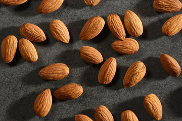 Almonds on the black stone texture