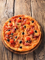 Delicious pizza served on wooden plate 