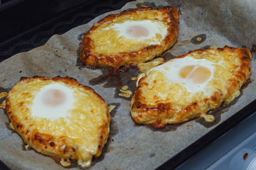 homemade khachapuri on a baking sheet