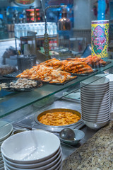 Cooked shrimps and pork meat inside kitchen counter of food stall