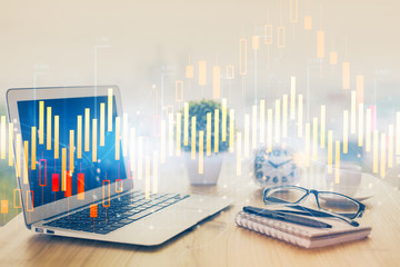 Forex graph hologram on table with computer background. Multi exposure. Concept of financial...
