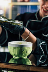 Chef Pouring Olive Oil into a Fresh Green Salad