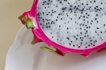 Exotic fruit, half dragon fruit or pitaya on a light background. space for text.