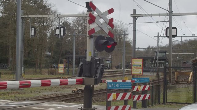 Closed railroad crossing near train station in the Netherlands
