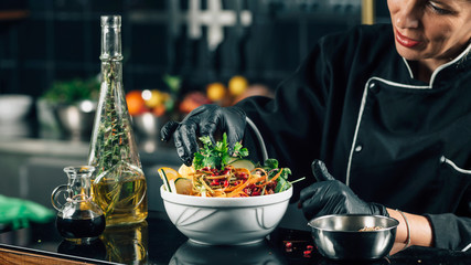 Chef in Restaurant, Decorating Vegan Salad with Parsley