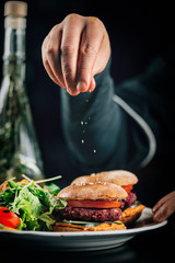 Chef in Restaurant, Decorating Vegan Burger with Sesame