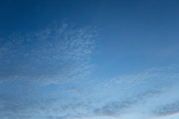 Naklejka na ściany i meble Spread cloud over the blue sky at night time, still havce sun light a bit