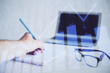 Multi exposure of man hands with stock market forex graph.