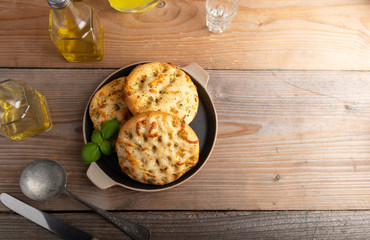 Freshly baked Italian bread Focaccia on a stone plate.