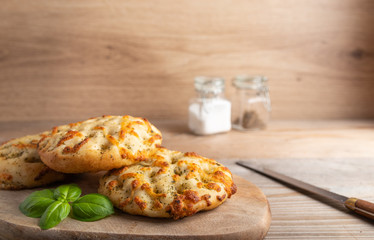 Freshly baked Italian bread Focaccia on a wooden plate.
