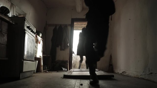 Special forces soldiers with weapons storm house
