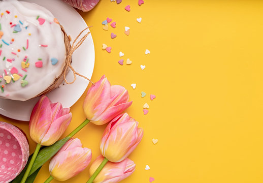 Easter Cake With Tulips, Eggs And Baking Items Top View On Yellow Background With Copy Space