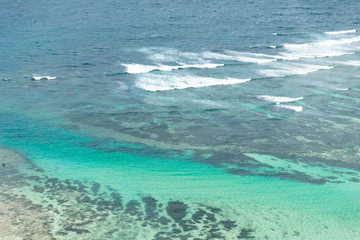 A beautiful ocean in Bali. The Pacific Ocean with large waves and tides that break on the rocks. The Indian Ocean is blue. Aqua Mente and Phantom Blue. Golden sunset on the ocean on the island of Bali