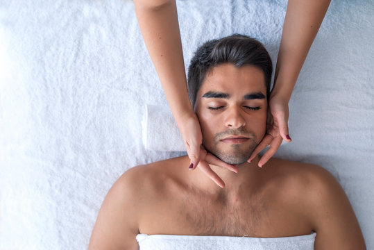 Handsome man at the spa getting a facial