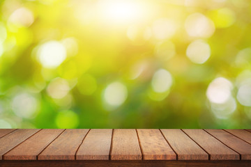 On an empty wooden table on a green bokeh abstract blur Light from the outside garden background  