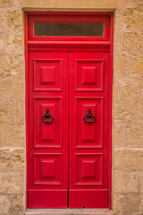 Vintage red door on stone house