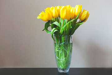 Yellow tulips in a vase with water