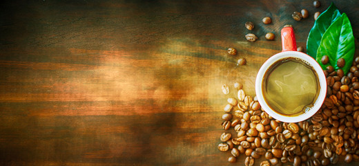 Coffee cup and coffee beans on table