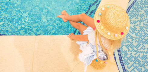 Pretty little girl in swimming pool, summer vacations.