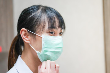 Close up Asian female physician wearing medical mask