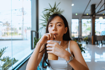 Asian women enjoying coffee, cappuccino