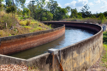 Irrigation channel for farming at Tinaroo Falls Dam on the Atherton Tablelands, Queenslandm, Australia, with low water due to drought.